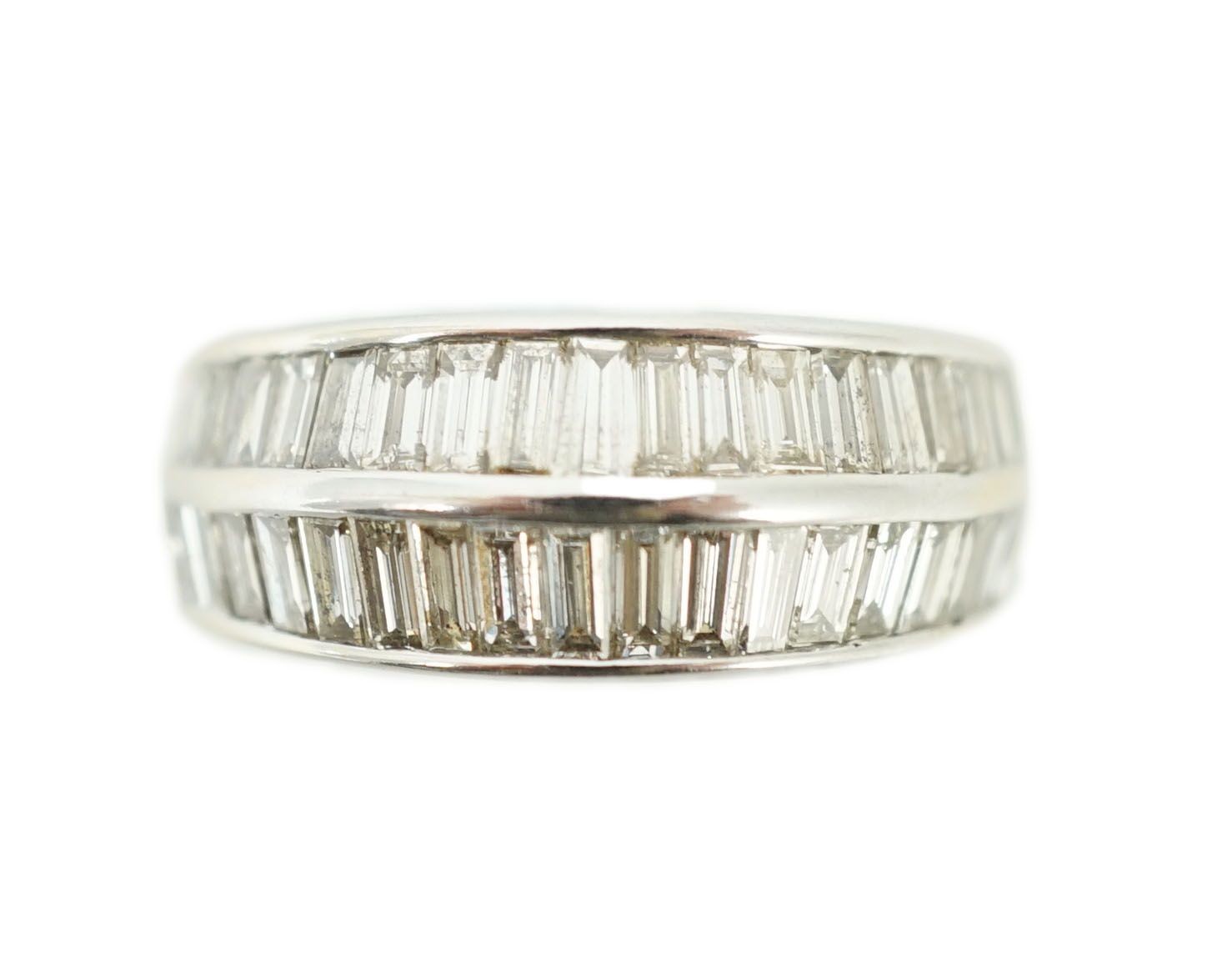 A modern 18k white gold and two row graduated baguette cut diamond set half hoop ring
